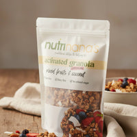 Package of Nutrinana's activated granola with a bowl of granola and fruits in the background.