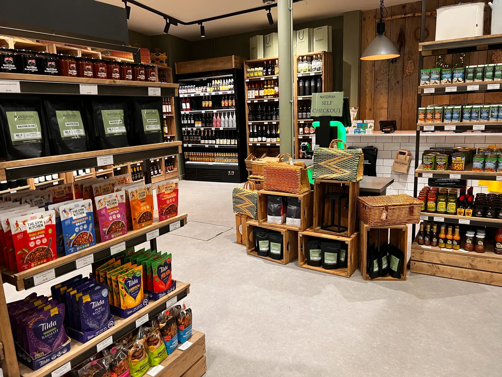 Grocery store interior with shelves stocked with products and wooden crates.