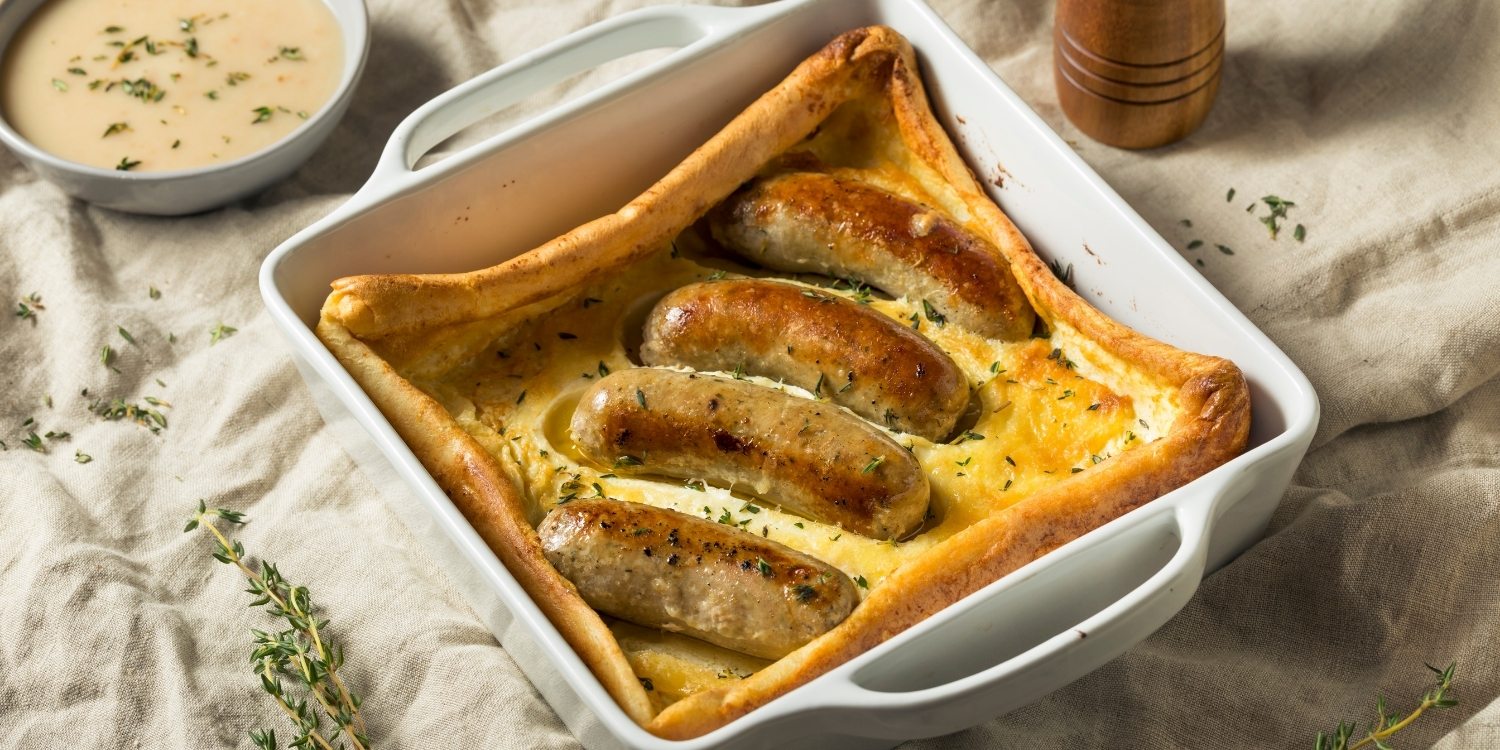 Traditional toad in a hole with sausages baked in golden batter, a classic British comfort dish