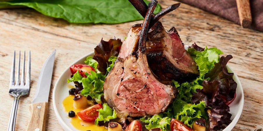Grilled rack of lamb with honey and chilli salad, charred and served as a bold centre-piece dish.