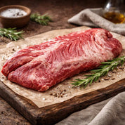 Onglet beef on a wooden cutting board with rosemary and salt
