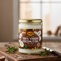 Jar of 100% Virgin Coconut Oil on a wooden surface with a blurred background