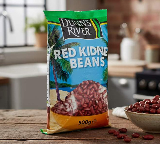 Dunns River Red Kidney Beans 500g pack on kitchen counter beside a bowl of soaked beans.