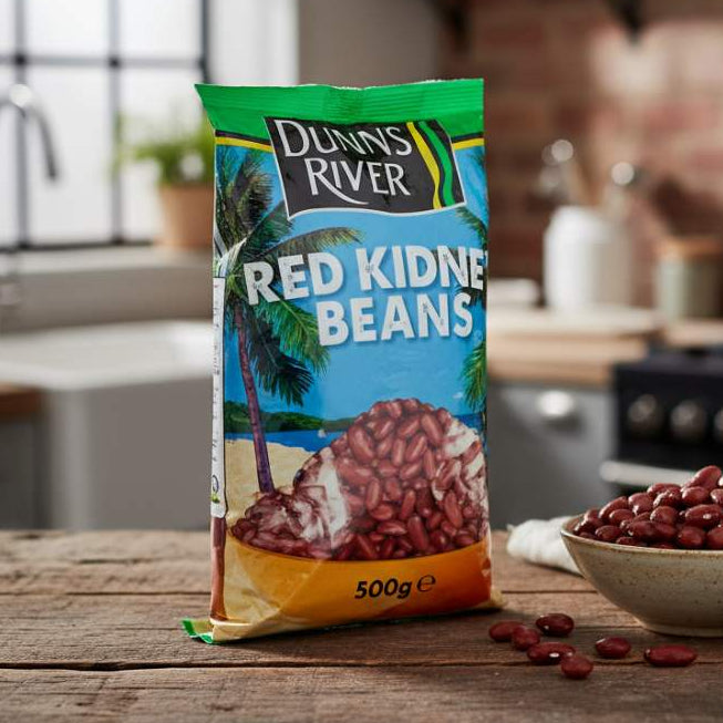 Dunns River Red Kidney Beans 500g pack on kitchen counter beside a bowl of soaked beans.