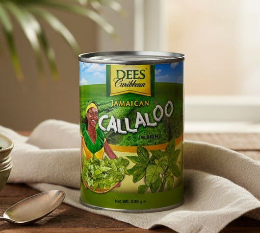 Can of Dees Caribbean Jamaican Callaloo on a wooden table with bowls and a spoon.