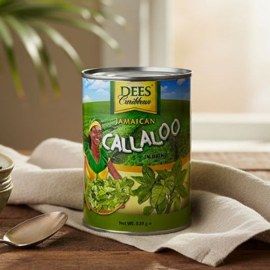 Can of Dees Caribbean Jamaican Callaloo on a wooden table with bowls and a spoon.