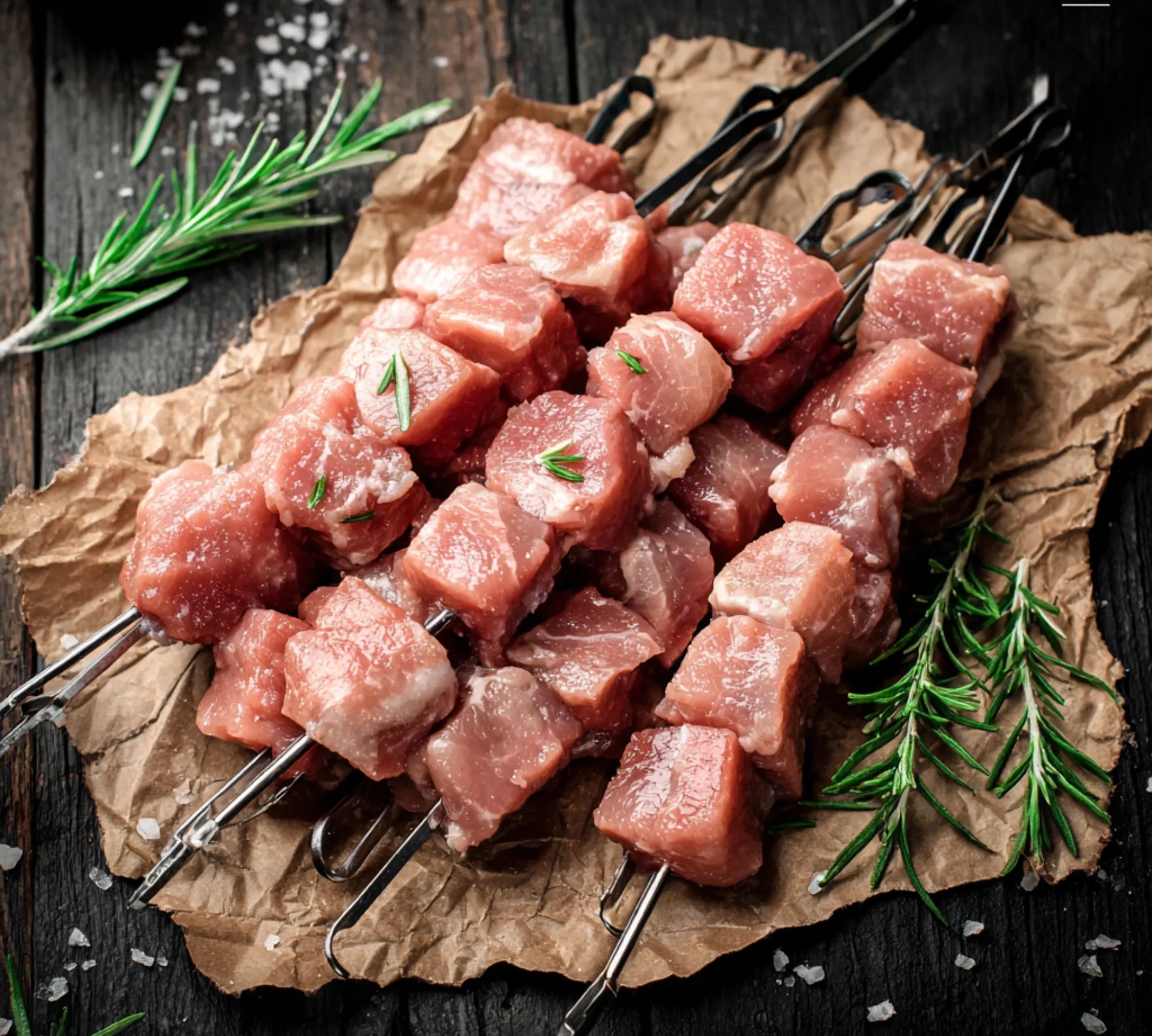 Diced gluten-free pork kebabs seasoned with herbs and spices, ready for grilling or cooking.