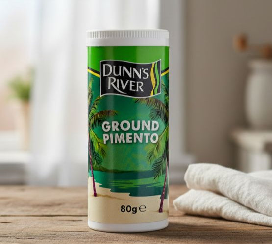 Dunn's River Ground Pimento container on a wooden surface with a blurred background