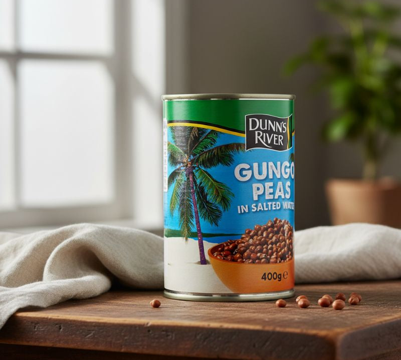 Can of Dunn's River Gungo Peas on a wooden surface with a neutral background