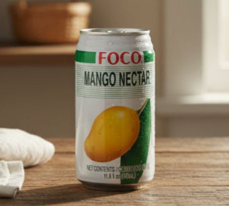 Can of Foco Mango Nectar on a wooden surface with a blurred background