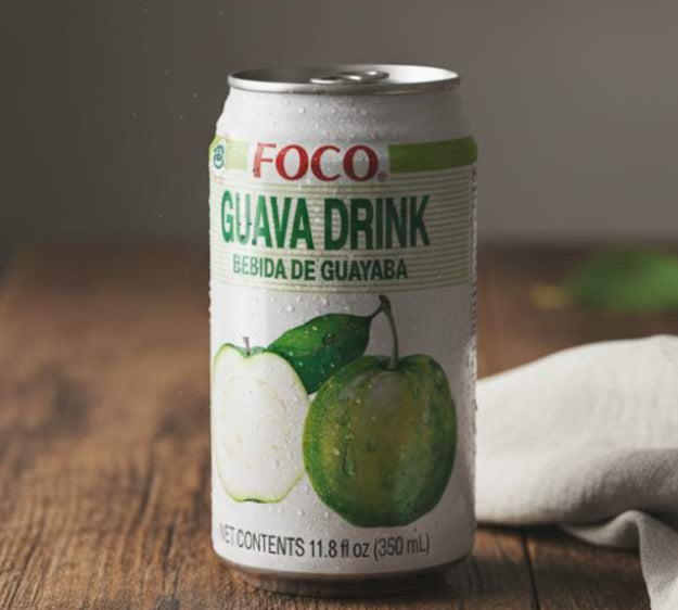 FOCO Guava Drink 350ml — tropical guava nectar can with ripe guavas on wooden table.