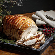 Cooked Boneless Rolled Turkey Breast Crown – golden, juicy roast served for Christmas dinner