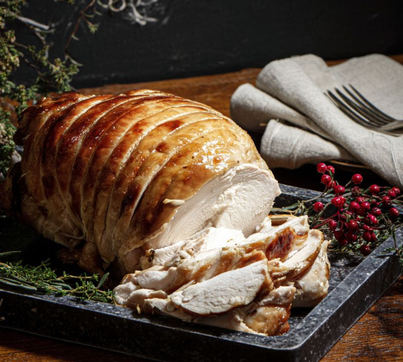 Cooked Boneless Rolled Turkey Breast Crown – golden, juicy roast served for Christmas dinner
