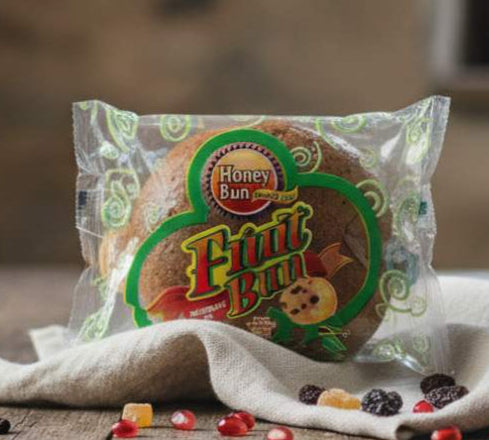 Packaged fruit bun on a wooden table with a blurred background