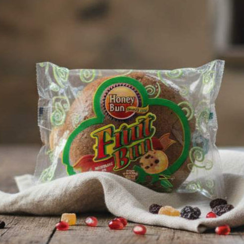 Packaged fruit bun on a wooden table with a blurred background