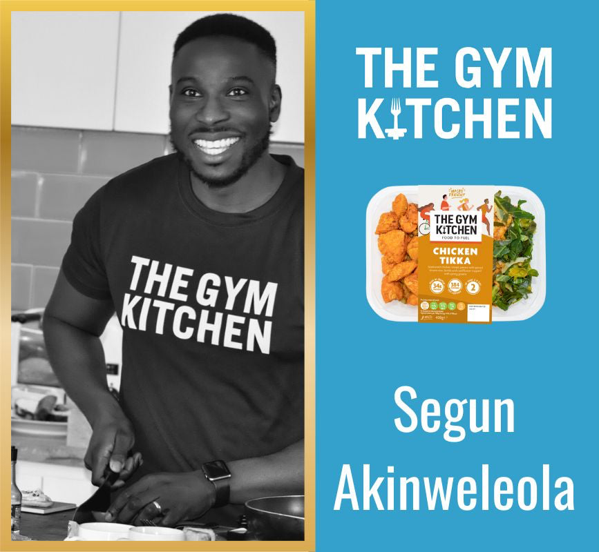 Person wearing a 'The Gym Kitchen' t-shirt with brand logo and text on a blue background