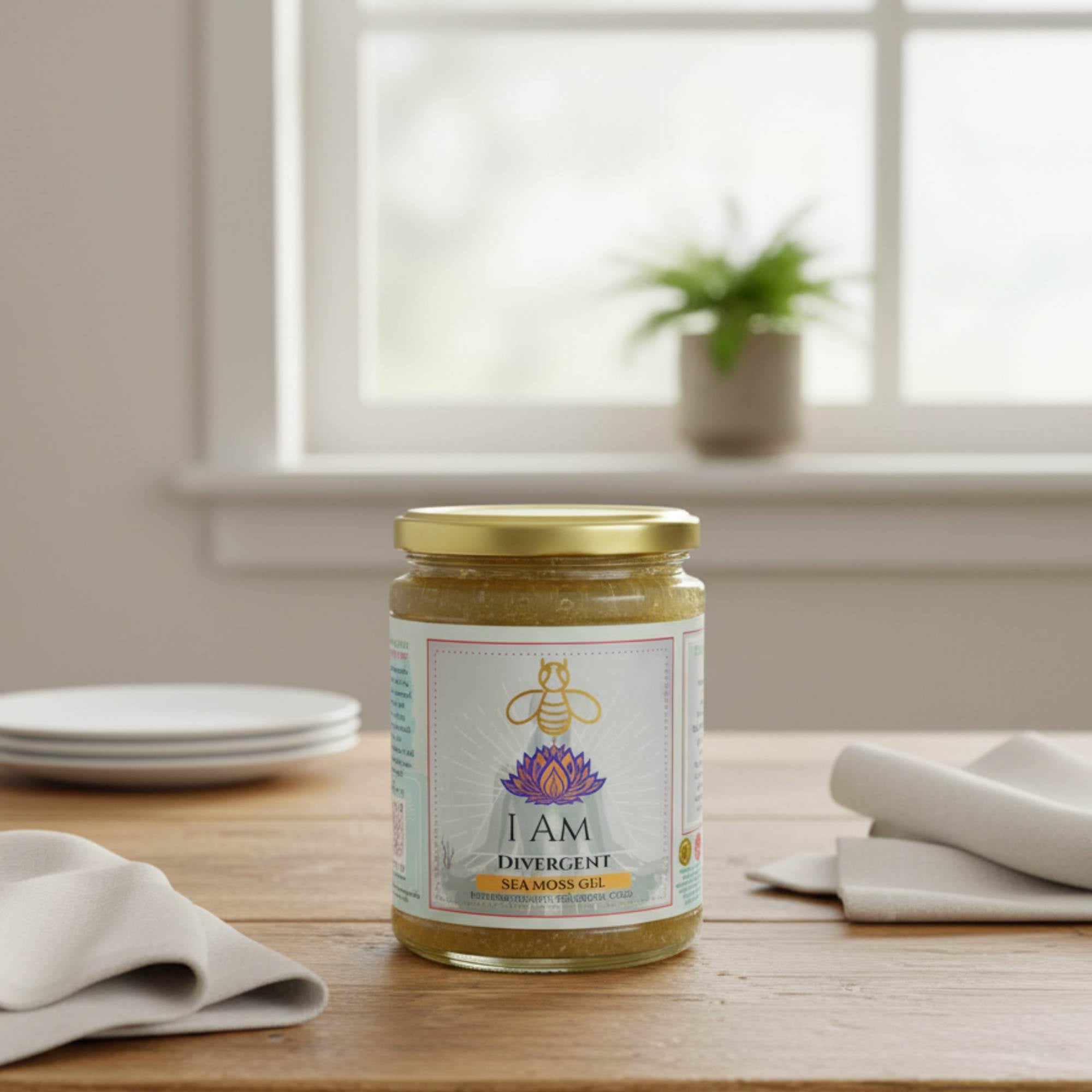 Jar of 'I AM Divergent' sea moss gel on a wooden table with a window in the background