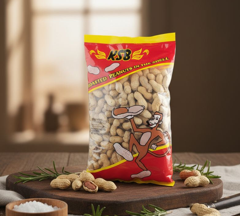 KSB roasted peanuts in shell packaging on a wooden board with peanuts scattered around.