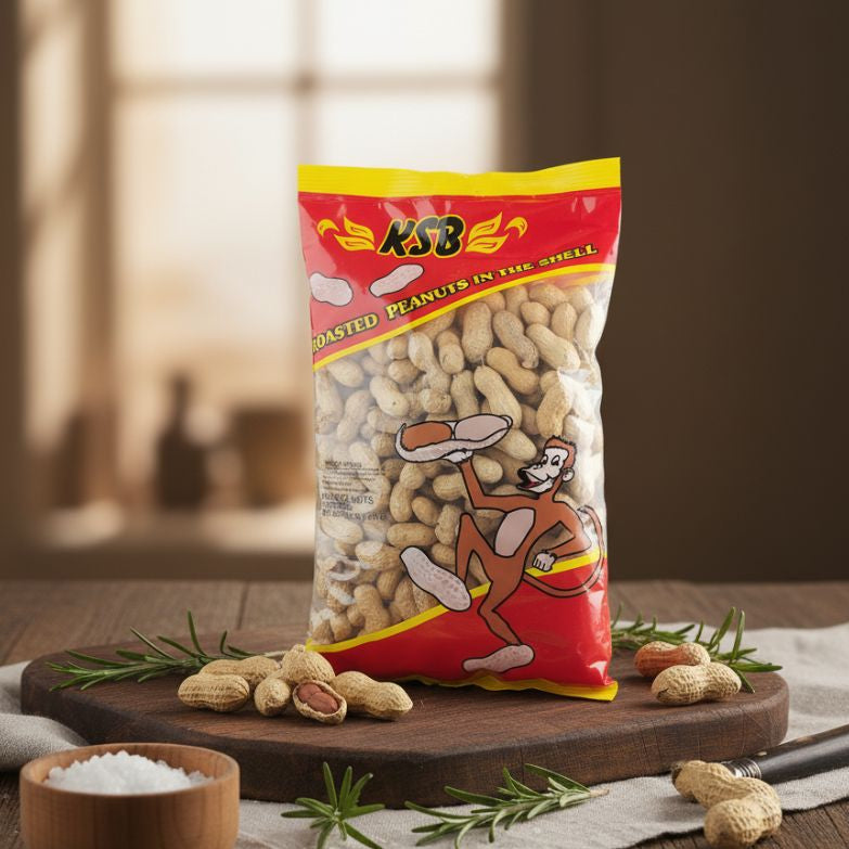 KSB roasted peanuts in shell packaging on a wooden board with peanuts scattered around.
