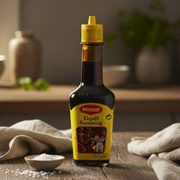 Maggi Liquid Seasoning 125g bottle on kitchen counter — soy-based umami flavour enhancer for cooking