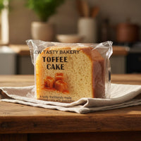 Packaged toffee cake from New Tasty Bakery on a wooden table with a kitchen background