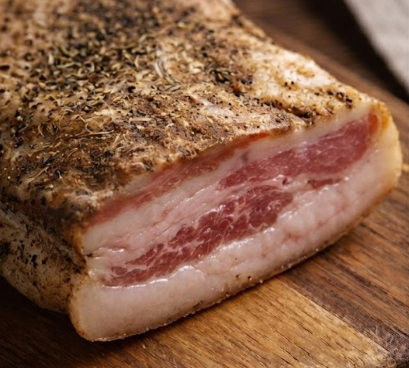 Pork Guanciale Cheek on a wooden cutting board