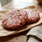 Gluten‑free Pork & Apple Burgers (2 × 6 oz/171 g) – British pork patties with apple flakes on wooden board