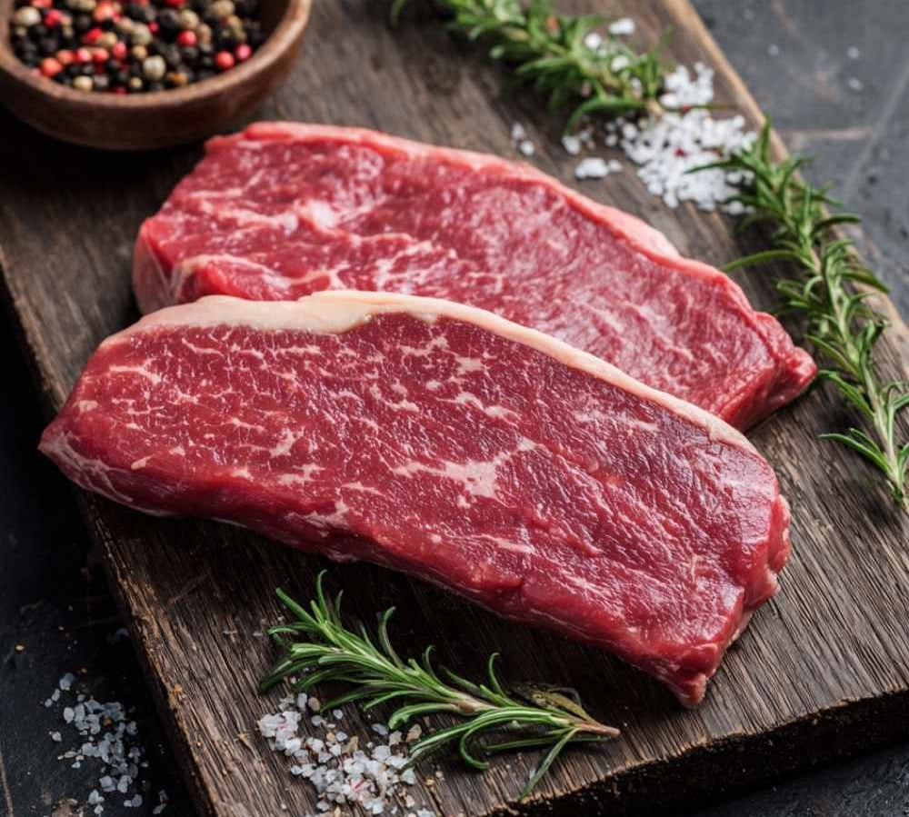 Fresh British grass-fed rump steak on display, rich red beef cut, premium butcher’s cut.