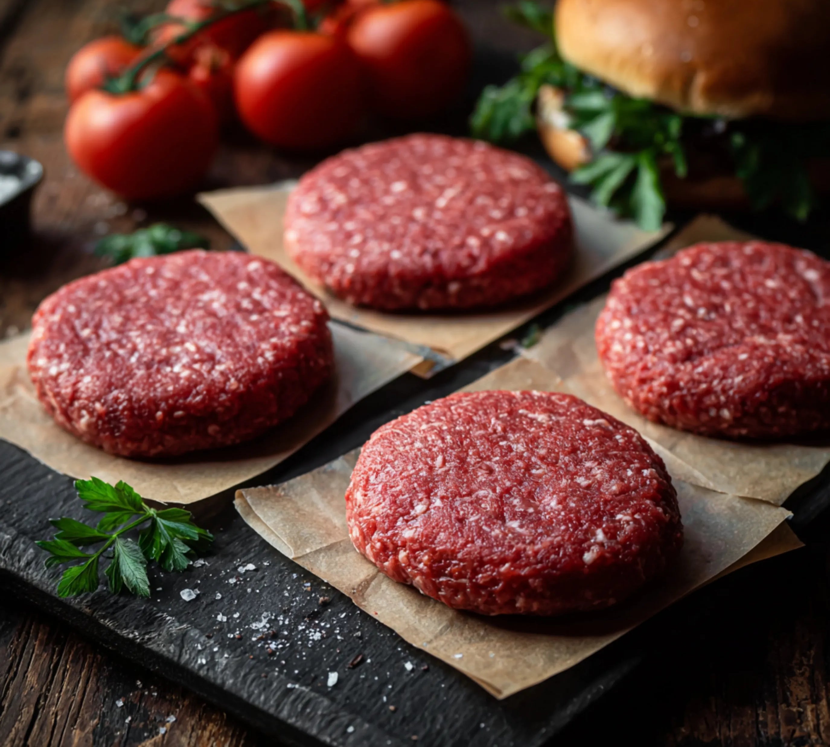 114g) – raw patties on parchment with tomatoes and herbs