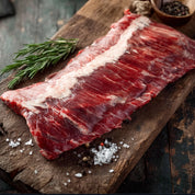 Raw meat on a wooden cutting board with rosemary and salt