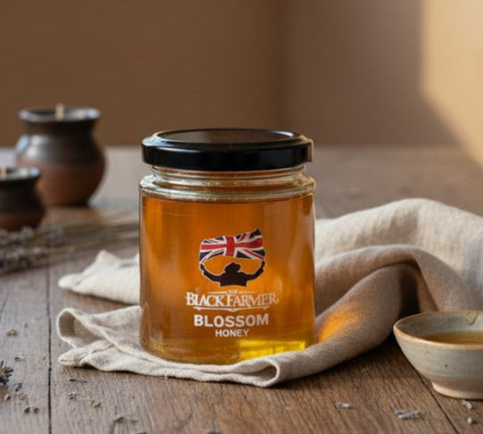 Jar of honey with a British flag label on a wooden table with a window in the background
