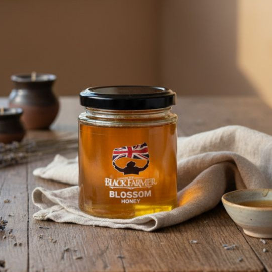 Jar of honey with a British flag label on a wooden table with a window in the background