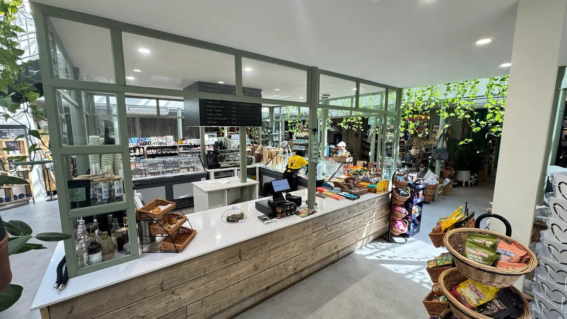 Modern store interior with a checkout counter and various products.