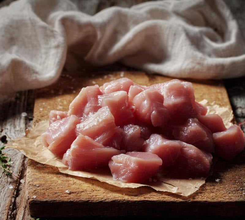 Diced free-range British turkey pieces in tray, lean high-protein poultry ideal for stir-fries and healthy meals.