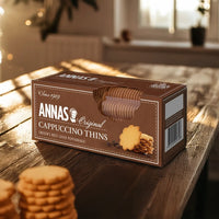 Anna's Cappuccino Thins box placed on a wooden table with soft natural lighting