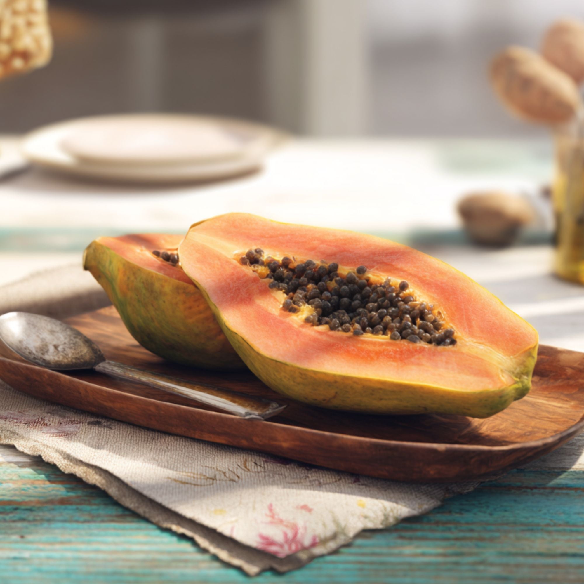 Fresh whole Caribbean papaya with vibrant orange flesh, sold individually by The Black Farmer