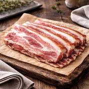 Rind-on smoked streaky bacon rashers on board, beechwood smoked British pork from The Black Farmer