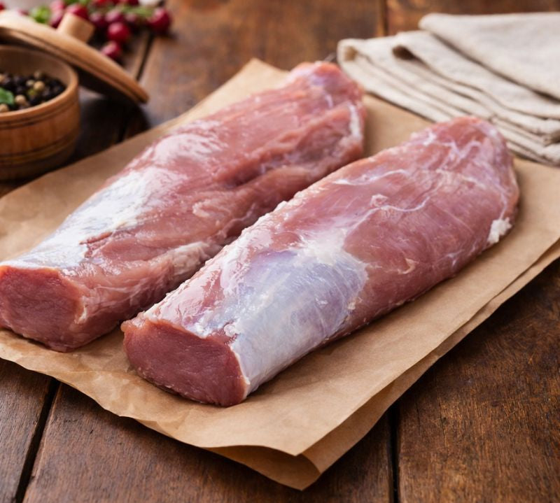 Free range pork tenderloin on a wooden board — premium British pork loin ideal for roasting, diced pork, pork chops and pork roast joints. Buy pork online.