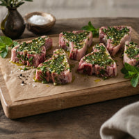 Minted British lamb loin chops, raw 200g portion, fresh marinated cut ideal for grilling or pan-frying.
