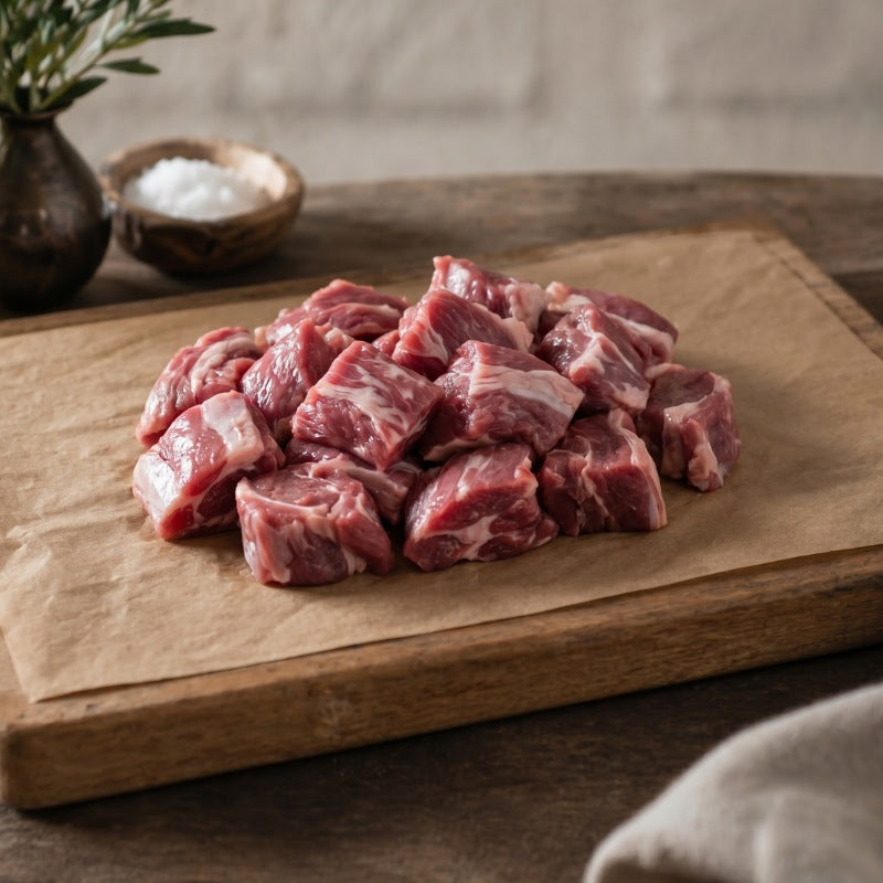 raw diced lamb shoulder on a wooden board
