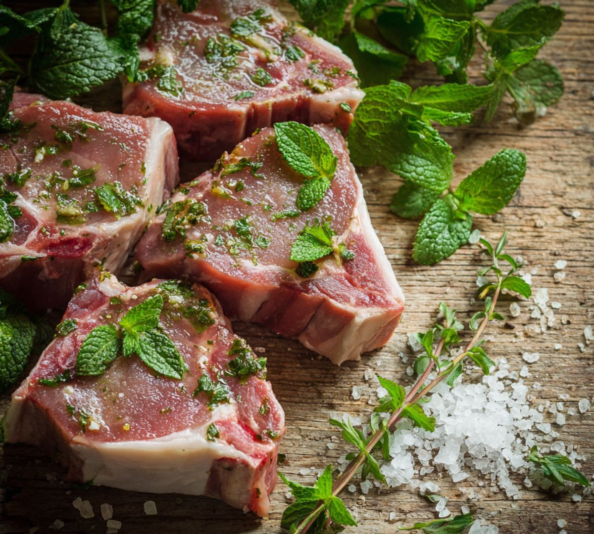 Minted British lamb loin chops, raw 200g portion, fresh marinated cut ideal for grilling or pan-frying.